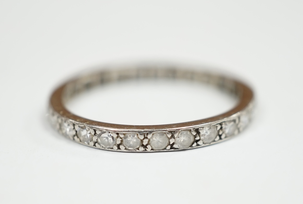A white metal and diamond set full eternity ring, size P, gross weight 2.6 grams. Condition - fair